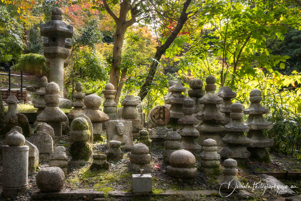 Kiyomizu dera Temple Graveyard stones with sunset light from behind